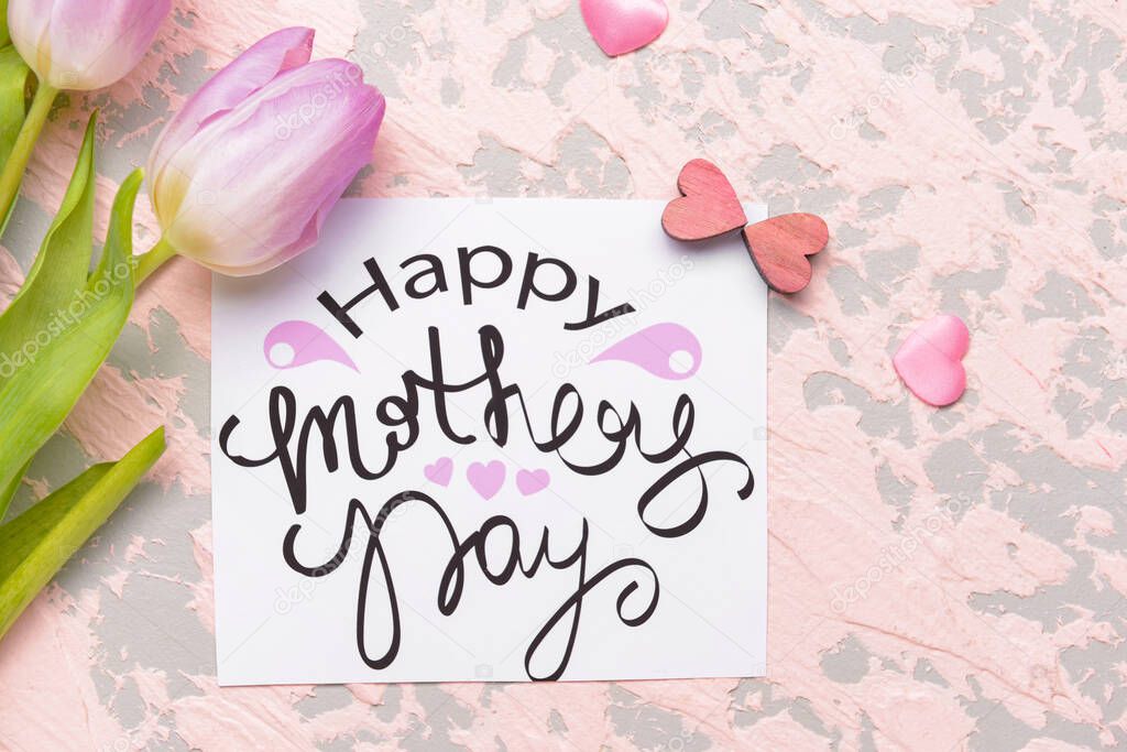 Beautiful greeting card and flowers for Mother's Day on color background