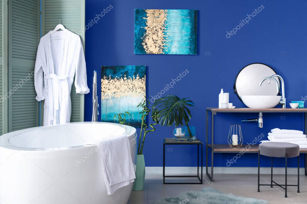Interior of modern bathroom with blue wall