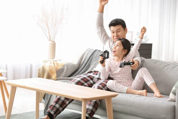 アジアの男と彼の小さな娘は自宅でビデオゲームをプレイ — ストック写真