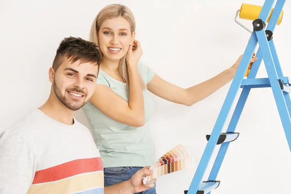 Junges Paar Wählt Wandfarbe Auf Weißem Hintergrund — Stockfoto