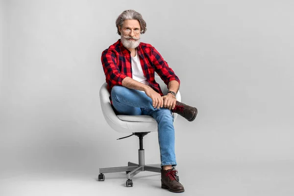Stylish Elderly Man Sitting Armchair Grey Background — Stock Photo, Image
