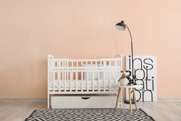 Baby bed near wall in interior of children\'s room