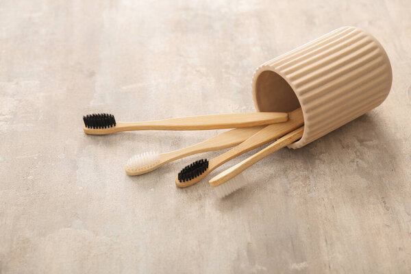 Holder with tooth brushes on light background