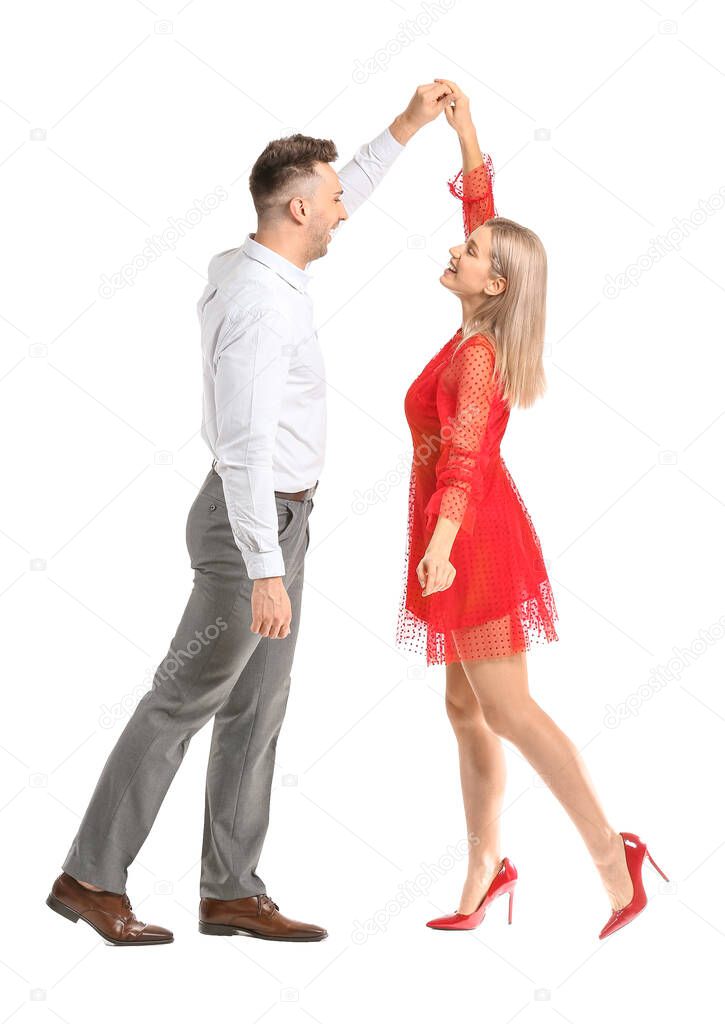 Happy dancing young couple on white background