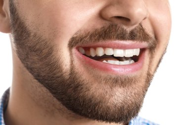 Handsome smiling young man on white background, closeup