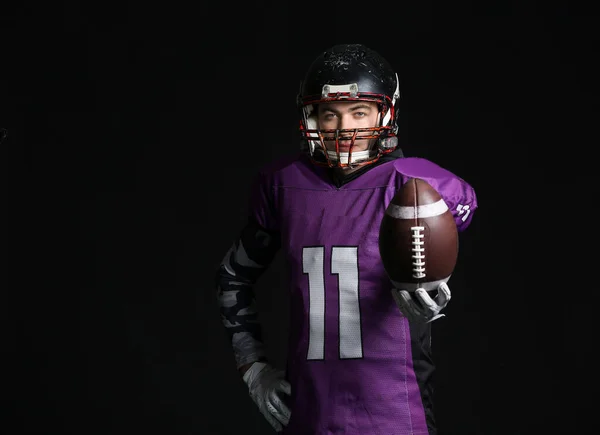 American football player on dark background