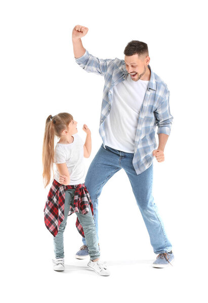 Father and his little daughter dancing against white background