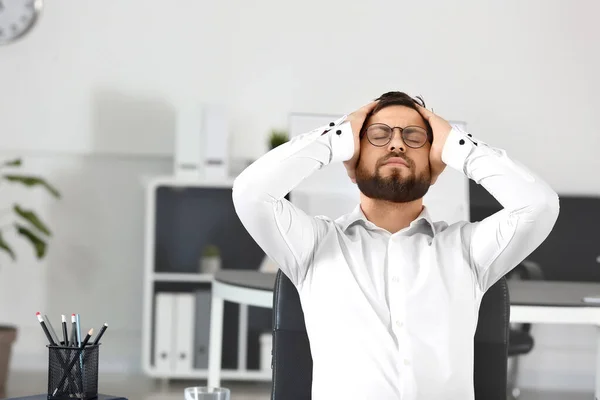 Young worried businessman in office