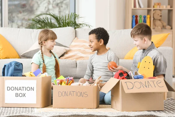 Little children with donations at orphan home