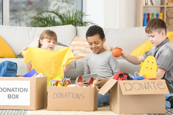 Little children with donations at orphan home