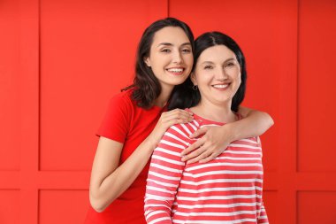 Renkli arka planda yetişkin kız ve annesinin portresi