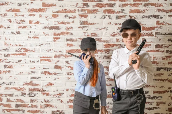 Cute Little Police Officers Brick Background — Stock Photo, Image