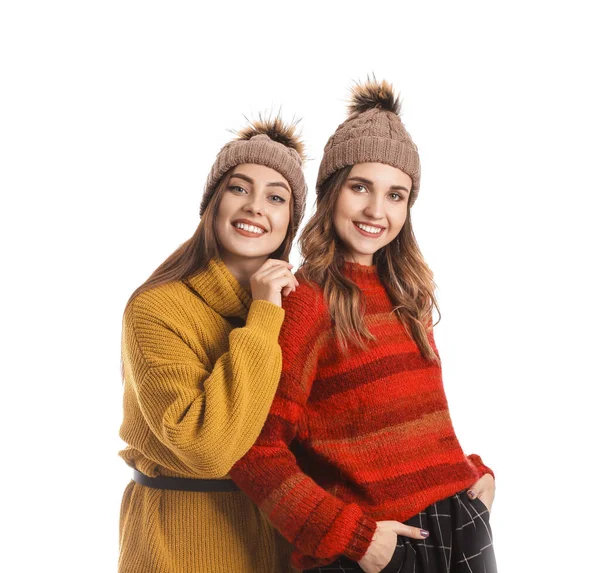 Beyaz arka planda kalın kazaklı genç kadınlar.