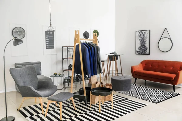 Interior of modern dressing room with stylish male clothes