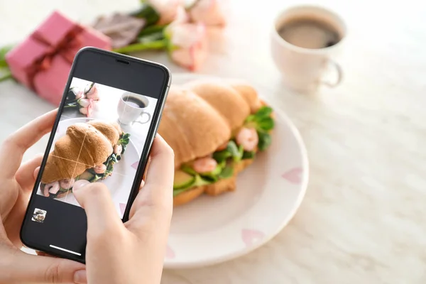 Woman Taking Photo Tasty Croissant Sandwich Table — Stock Photo, Image