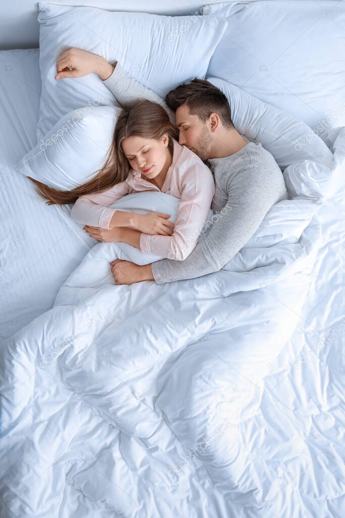 Young couple sleeping in bed