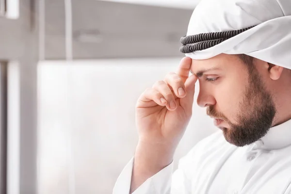 Arab businessman near window in office