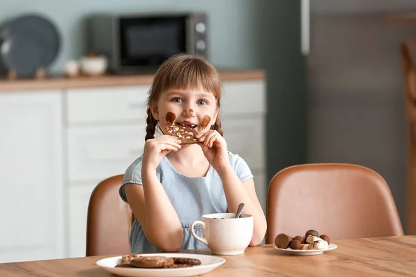 Cute Little Girl Eating Chocolate Kitchen — Stock Photo, Image