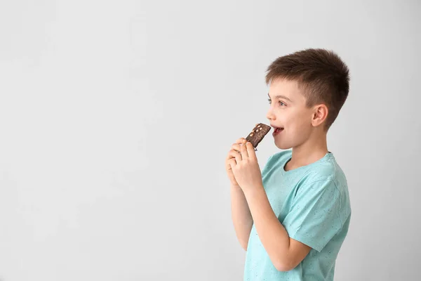 Cute Little Boy Eating Chocolate Light Background — Stock Photo, Image