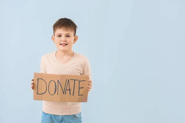 Little Boy Holding Cardboard Text Donate Color Background — Stock Photo, Image