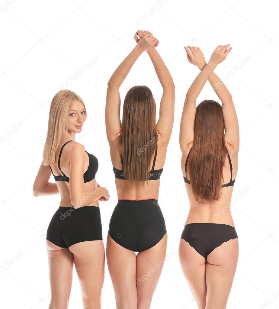Beautiful young women in underwear on white background