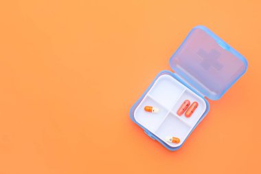 Renk arkaplanında çizilmiş yüzleri olan kutular ve haplar