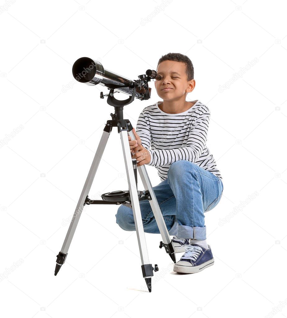 Little African-American boy with telescope on white background