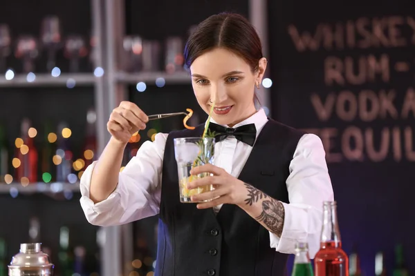 Beautiful female bartender in pub