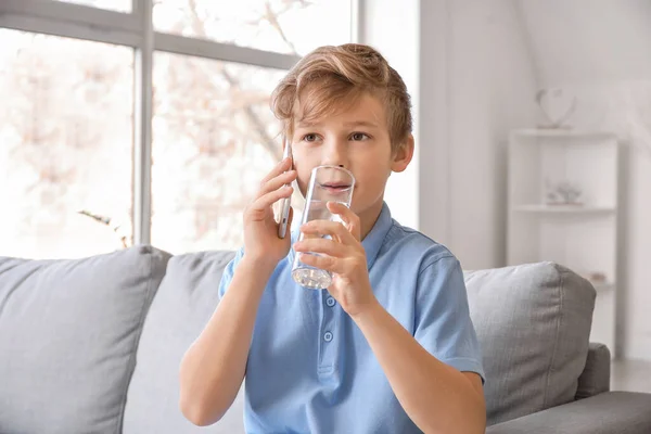 Cute Little Boy Drinking Water While Talking Phone Home — Stock Photo, Image