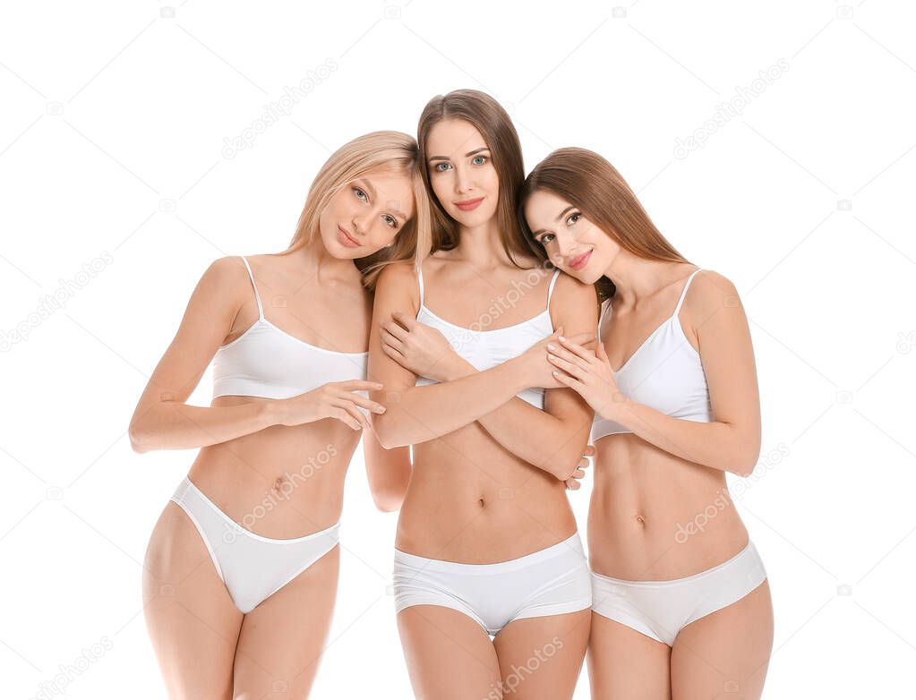 Beautiful young women in underwear on white background