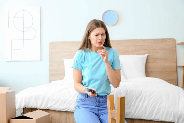 Young Woman Blowing Finger Assembling Furniture Home — Stock Photo, Image
