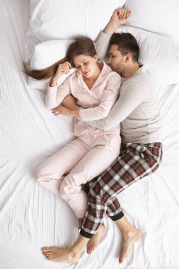 Genç çift yatakta uyuyor.