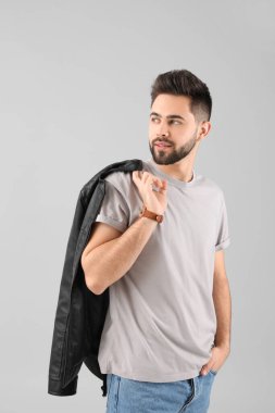 Açık arkaplanda sağlıklı saçlı yakışıklı bir adam.