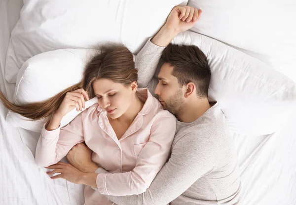 若いカップルがベッドで寝ていて — ストック写真