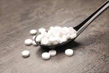 Ahşap arka planda haplı kaşık