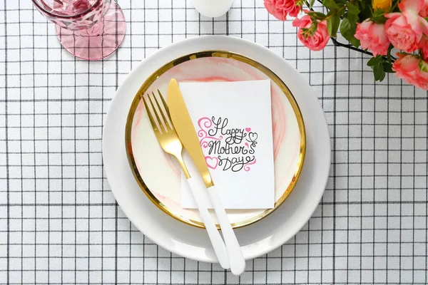 Table setting with card for Mother\'s day dinner