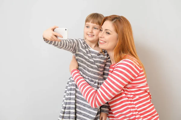 Woman Her Little Daughter Taking Selfie Light Background — Stock Photo, Image