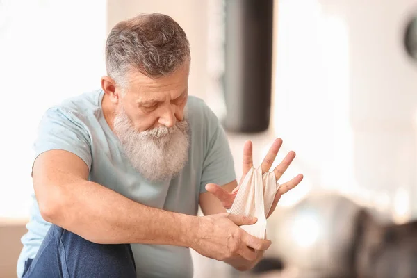 Sporty Elderly Man Applying Wrist Bands Gym — Stock Photo, Image