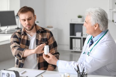 Genç adam klinikte reçeteli ilaç almayı reddediyor.