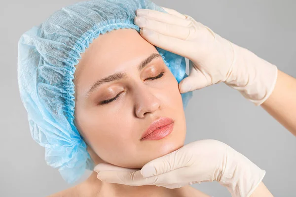 Plastic Surgeon Examining Face Young Woman Grey Background — Stock Photo, Image