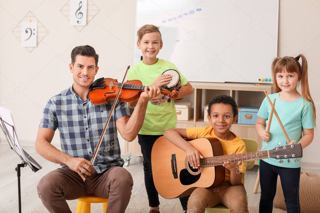 Teacher giving music lessons at school