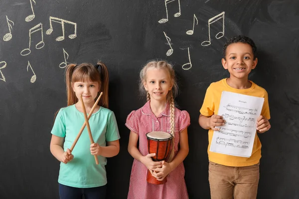 Little children near chalkboard at music school