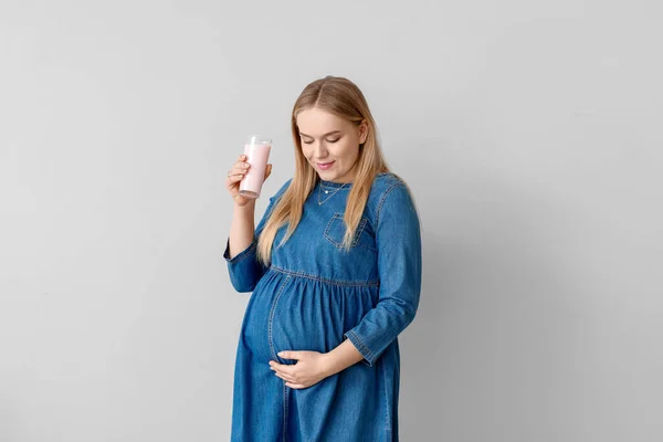 Hermosa Mujer Embarazada Con Yogur Sobre Fondo Claro — Foto de Stock