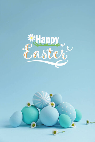 Beautiful eggs with flowers and text HAPPY EASTER on color background