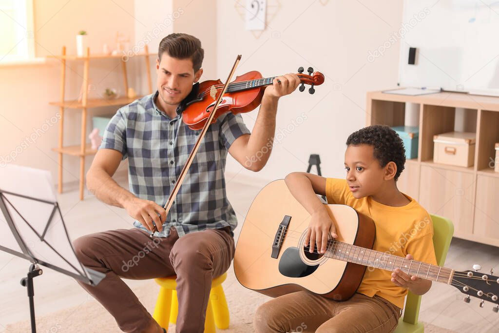 Teacher giving music lessons at school