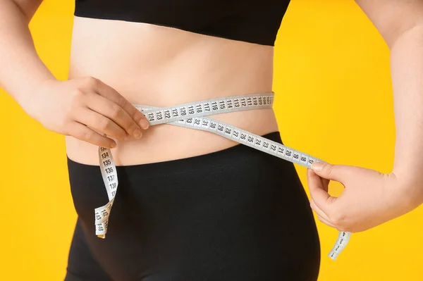 色の背景にテープを測定して太りすぎの女性 クローズアップ 減量の概念 — ストック写真