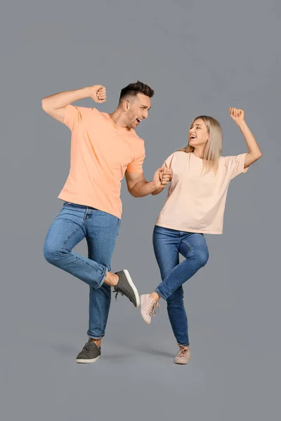 Happy Dancing Young Couple Grey Background — Stock Photo, Image