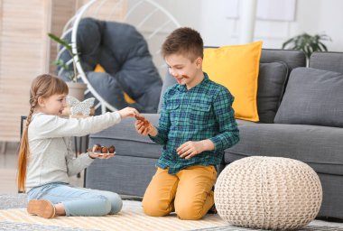Evde çikolata yiyen şirin çocuklar.