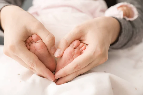 Madre Sostiene Pequeños Pies Bebé Primer Plano —  Fotos de Stock