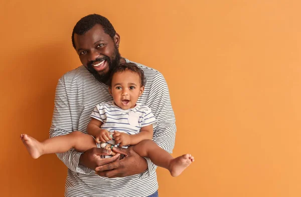 Happy African American Man Cute Baby Color Background — Stock Photo, Image